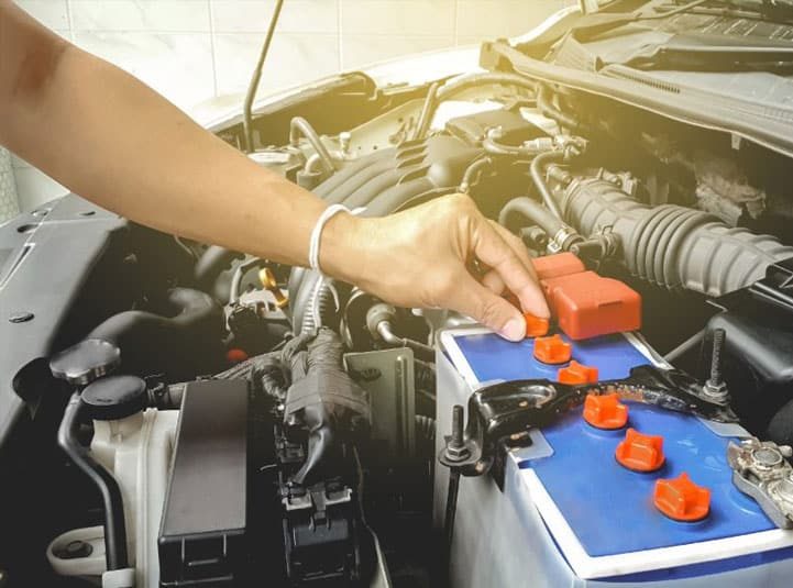 Mechanic Making Adjustments to Car Battery — Goodyear Auto Care In Toowoomba, QLD