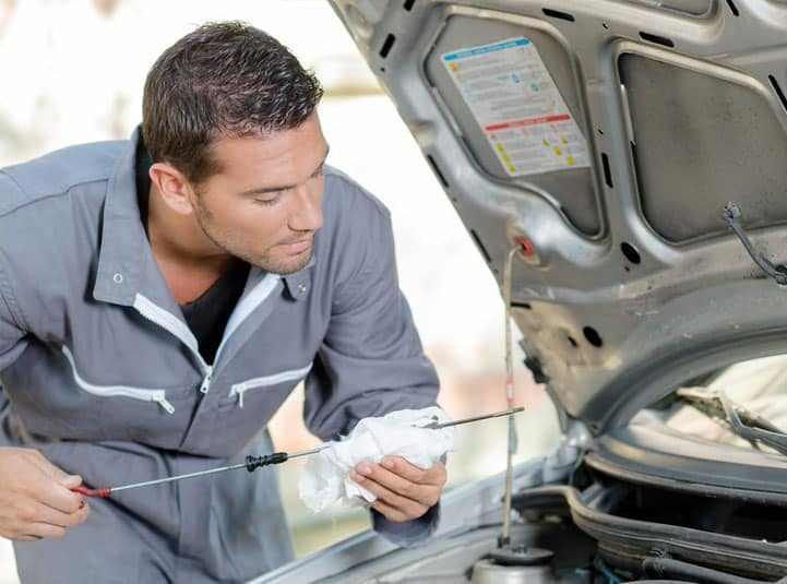 Mechanic Checking Oil Levels — Goodyear Auto Care In Toowoomba, QLD