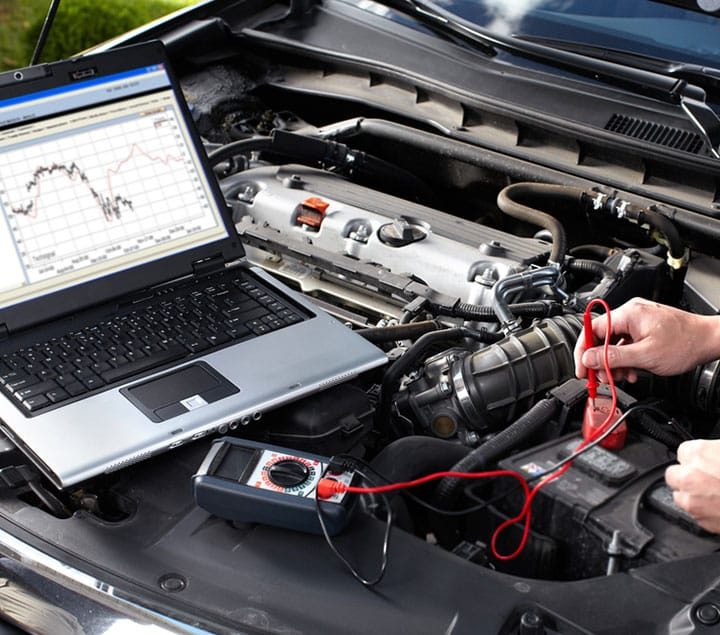 Mechanic Testing Car Battery — Goodyear Auto Care In Toowoomba, QLD