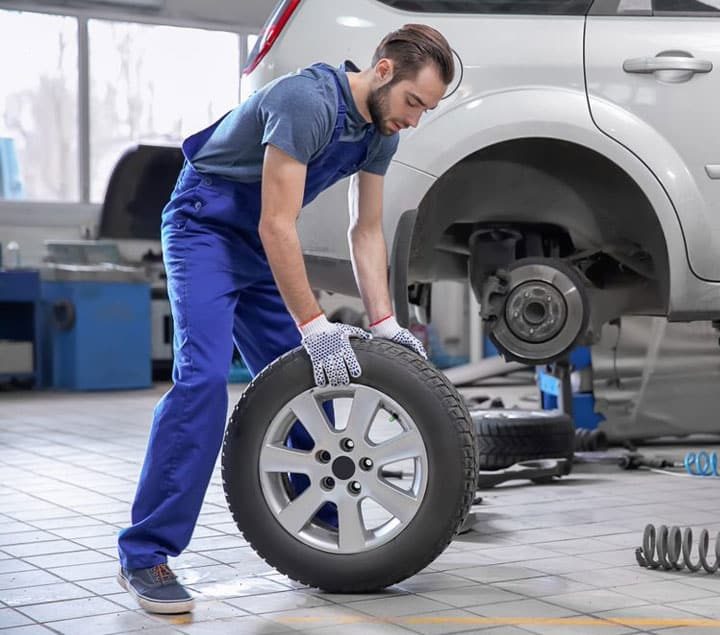 Mechanic Working on Tyre Replacement — Goodyear Auto Care In Toowoomba, QLD